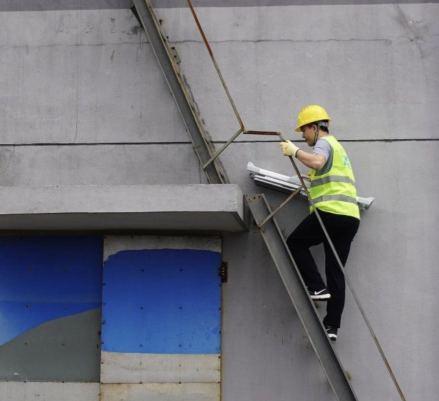 Crew member climbing a steep ladder to a solar installation
